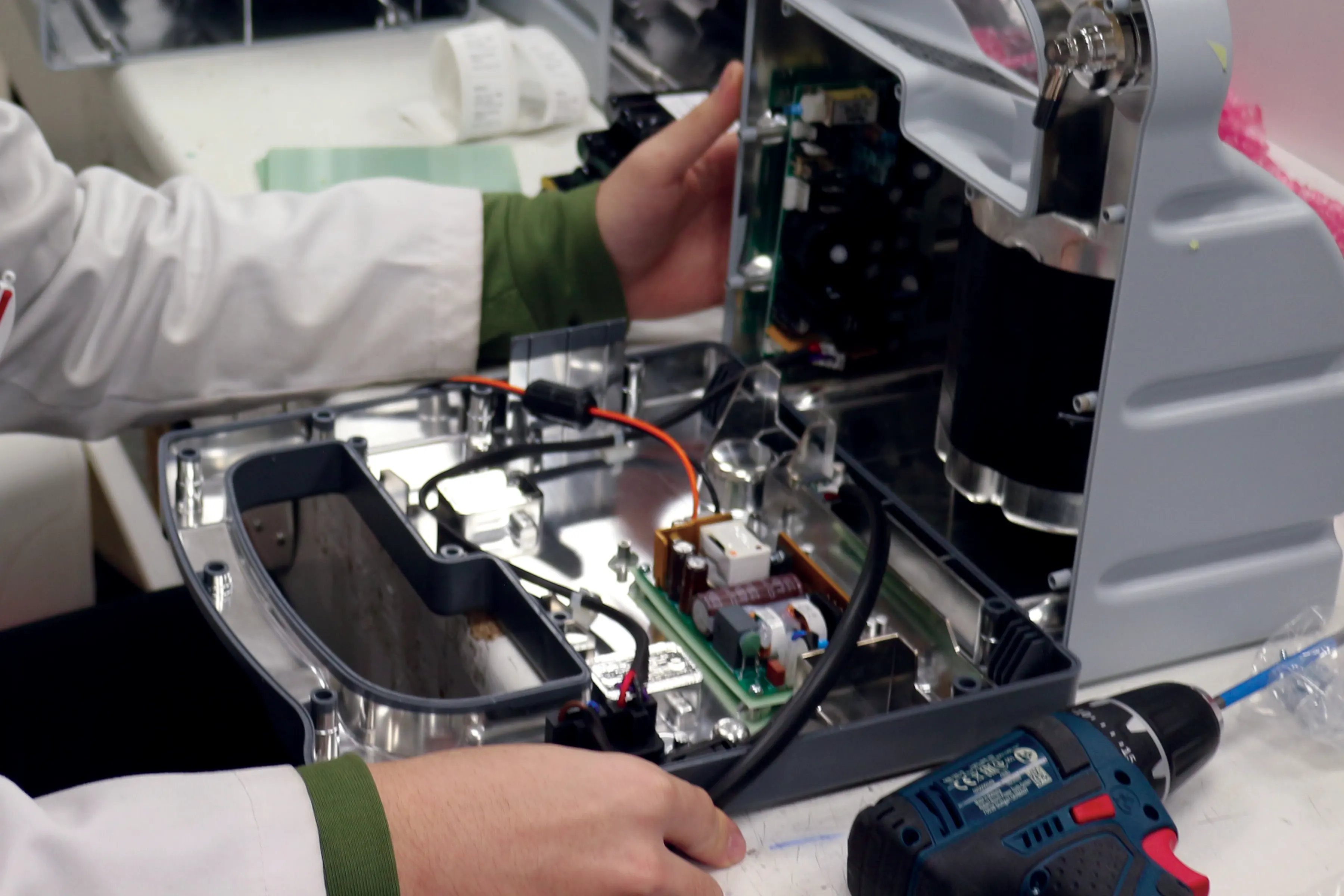An Oxylitre technician servicing a suction pump on the bench